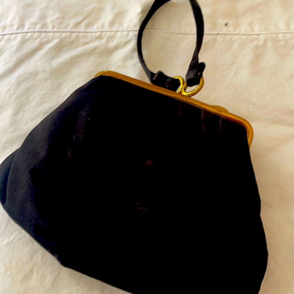 A women’s wrist black and gold satin evening  bag/clutch